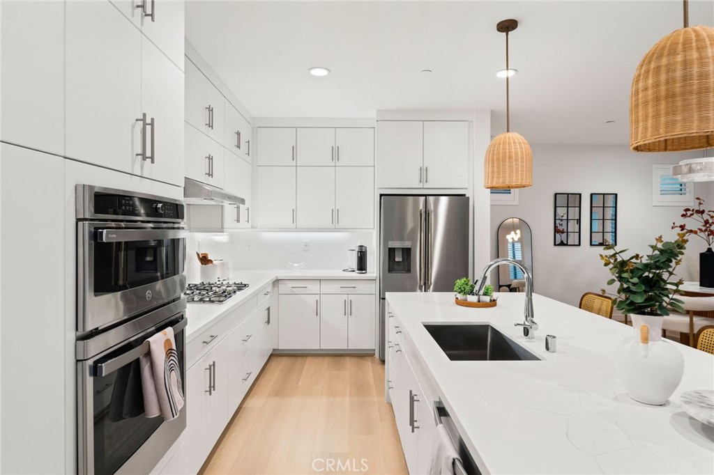 127 Restore Irvine, CA 92618 - Photo 9 of 65 a kitchen with white cabinets and stainless steel appliances