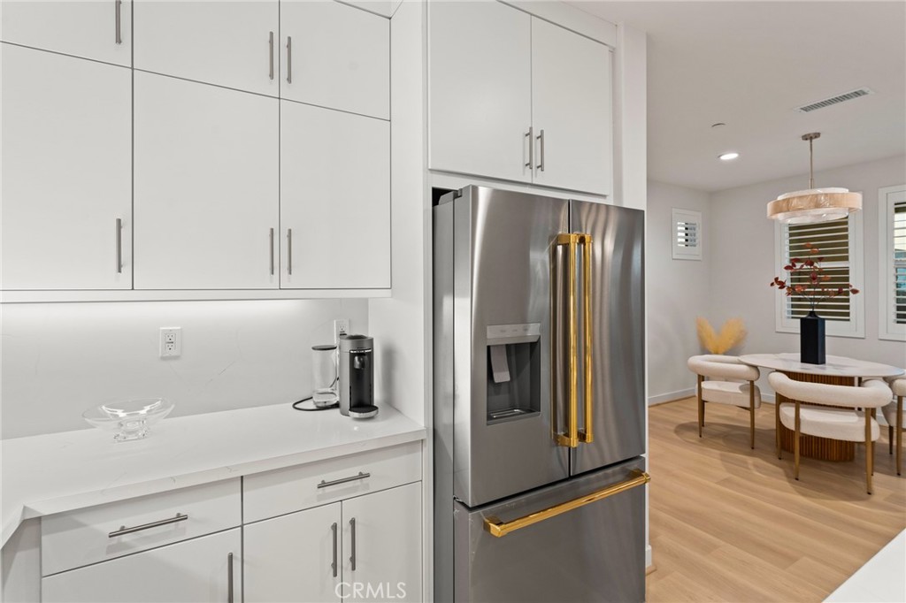 127 Restore Irvine, CA 92618 - Photo 10 of 65 a kitchen with stainless steel appliances a refrigerator sink and cabinets
