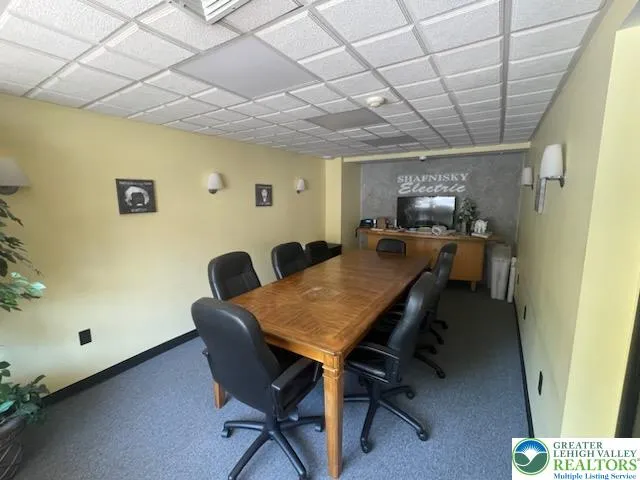 a view of a dining room with furniture and a chandelier