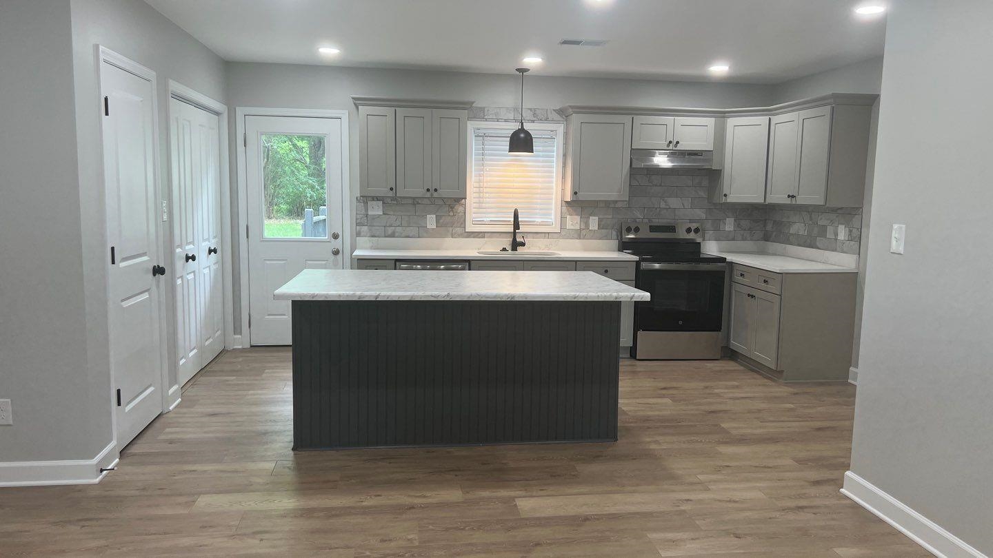 4411 Helene Road Memphis, TN 38117 - Photo 2 of 13 a kitchen with kitchen island granite countertop a sink stove and refrigerator