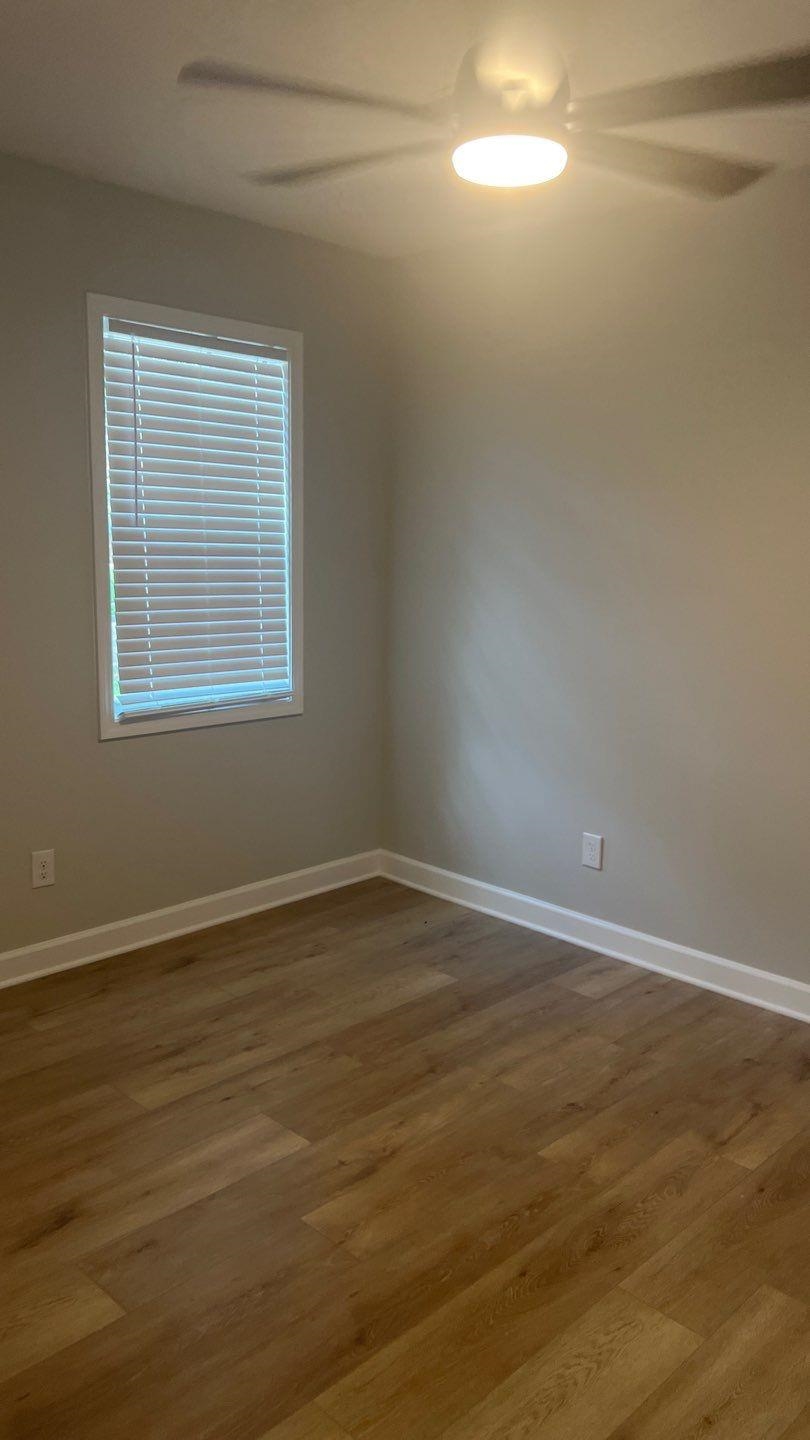 4411 Helene Road Memphis, TN 38117 - Photo 4 of 13 a view of an empty room with wooden floor and a window