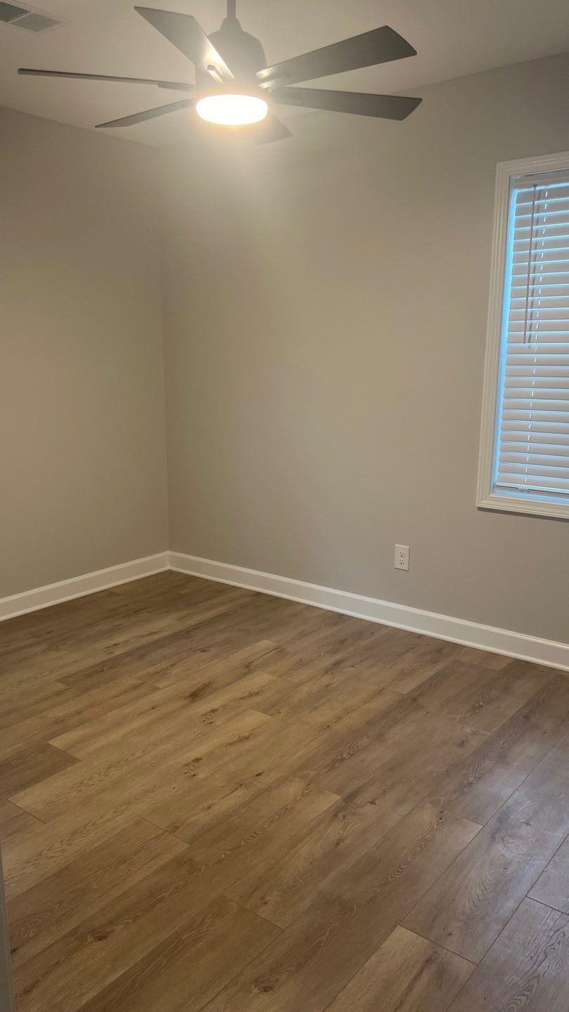 4411 Helene Road Memphis, TN 38117 - Photo 6 of 13 a view of a room with wooden floor and windows on ceiling fan