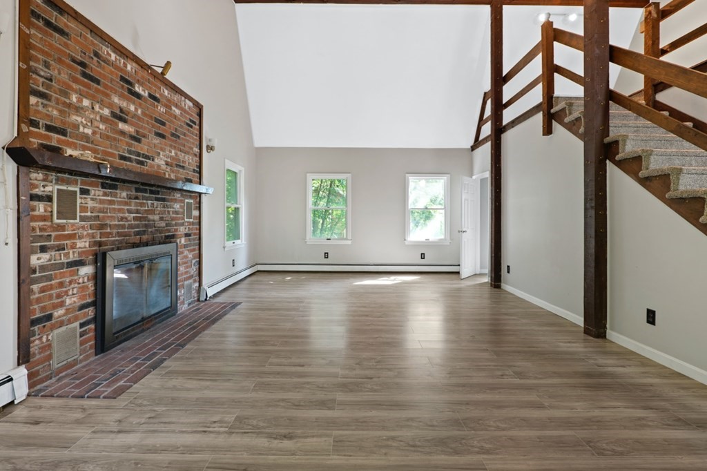 549 Main Street Townsend, MA 01474 - Photo 11 of 41 a view of a livingroom with wooden floor and a fireplace
