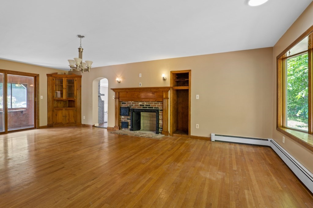 549 Main Street Townsend, MA 01474 - Photo 16 of 41 wooden floor fireplace and natural light in room