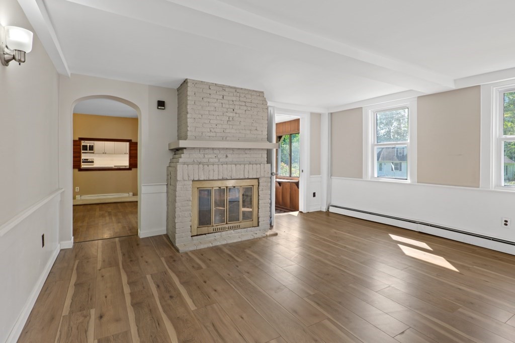 549 Main Street Townsend, MA 01474 - Photo 19 of 41 wooden floor fireplace and windows in an empty room