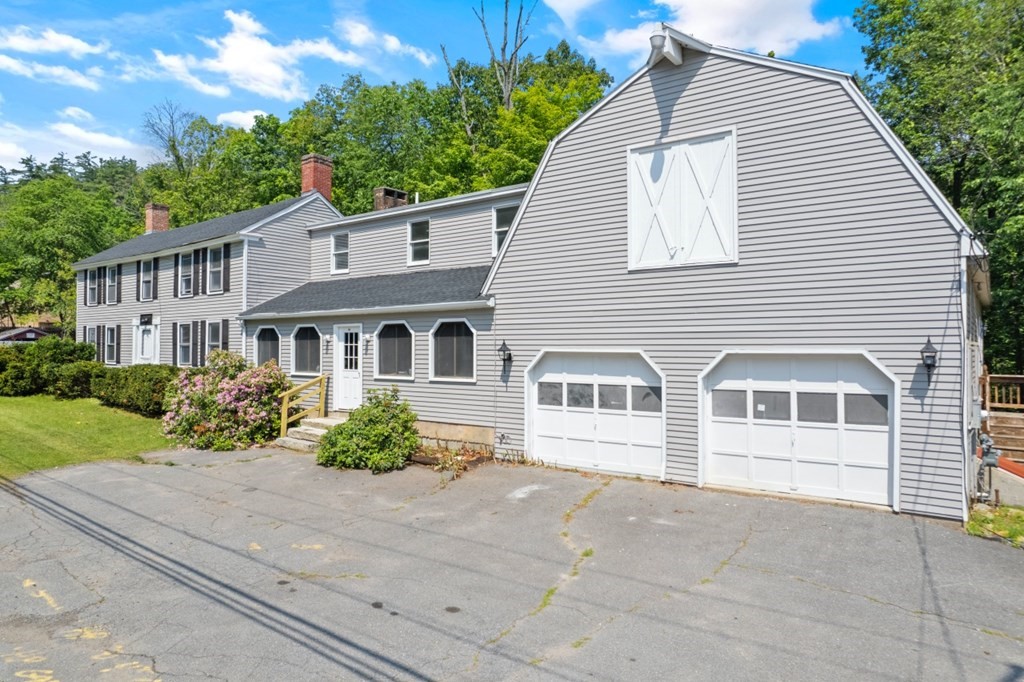 549 Main Street Townsend, MA 01474 - Photo 38 of 41 a view of a white house with a yard and potted plants
