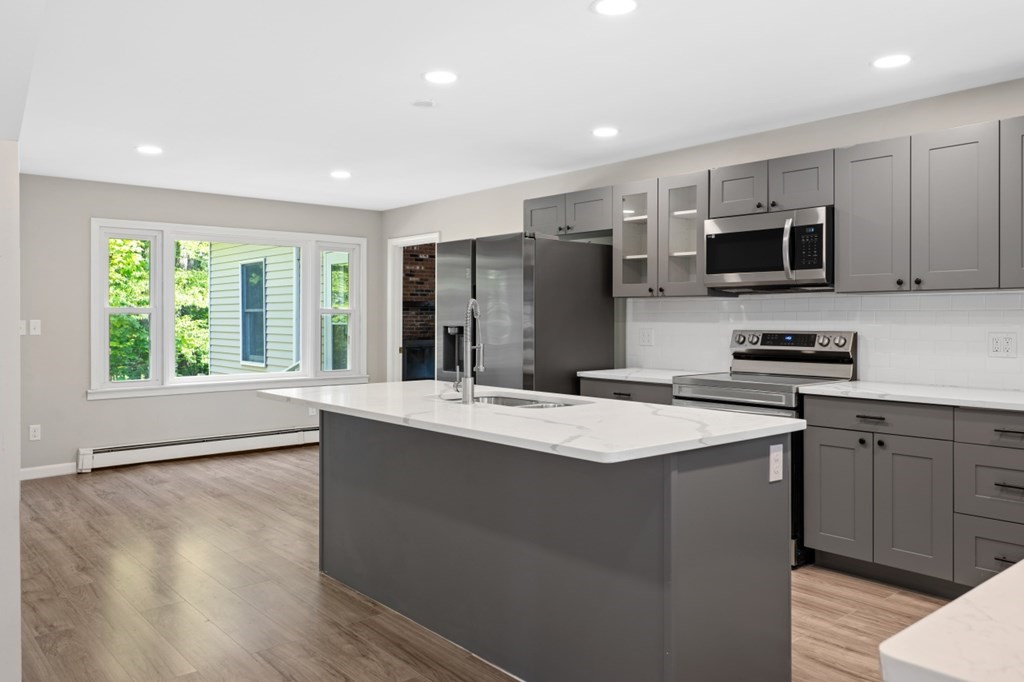 549 Main Street Townsend, MA 01474 - Photo 4 of 41 a kitchen with stainless steel appliances granite countertop a stove a sink and a refrigerator