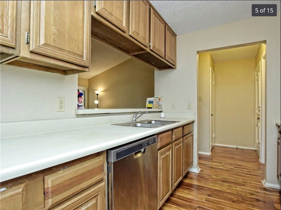 806 West 24th Street, Unit 331 Austin, TX 78705 - Photo 9 of 12 a kitchen with stainless steel appliances granite countertop a sink and dishwasher a stove with wooden floor