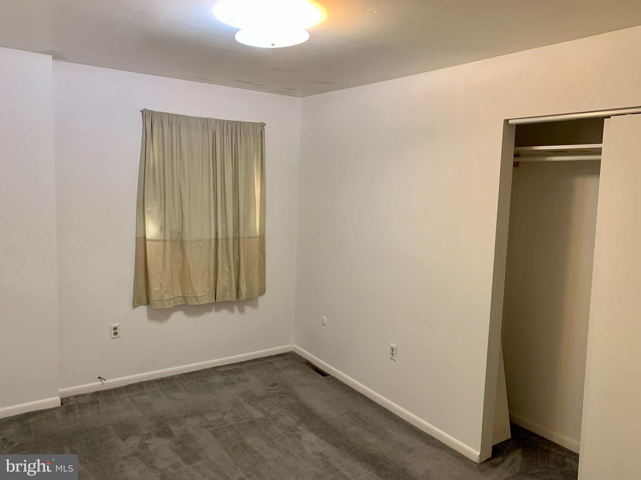 1207 Scott Street Reading, PA 19611 - Photo 12 of 25 an empty room with windows and closet