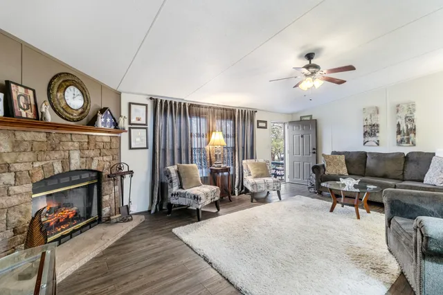 a living room with furniture a flat screen tv and a fireplace