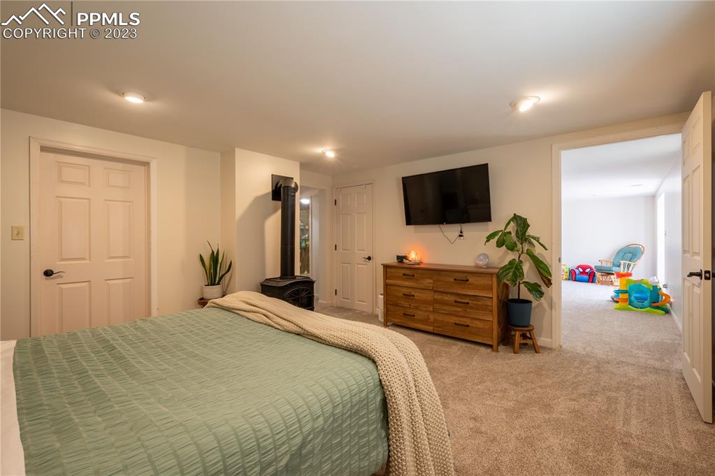 24141 Eccles Street Elbert, CO 80106 - Photo 14 of 37 a bedroom with a bed and flat screen tv