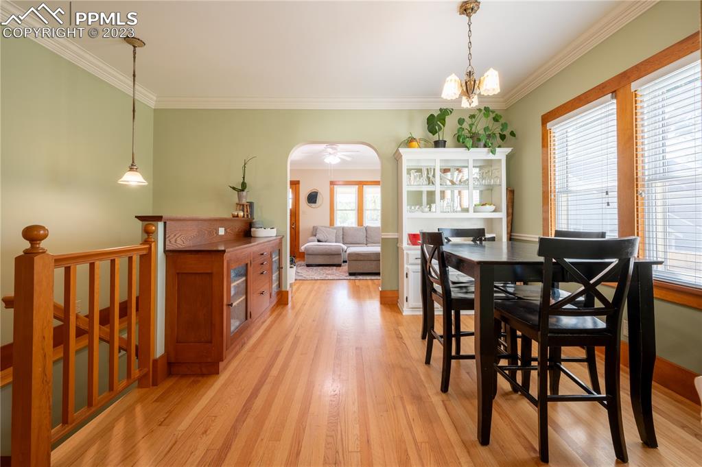 24141 Eccles Street Elbert, CO 80106 - Photo 21 of 37 a dining room with wooden floor a chandelier a wooden table and chairs