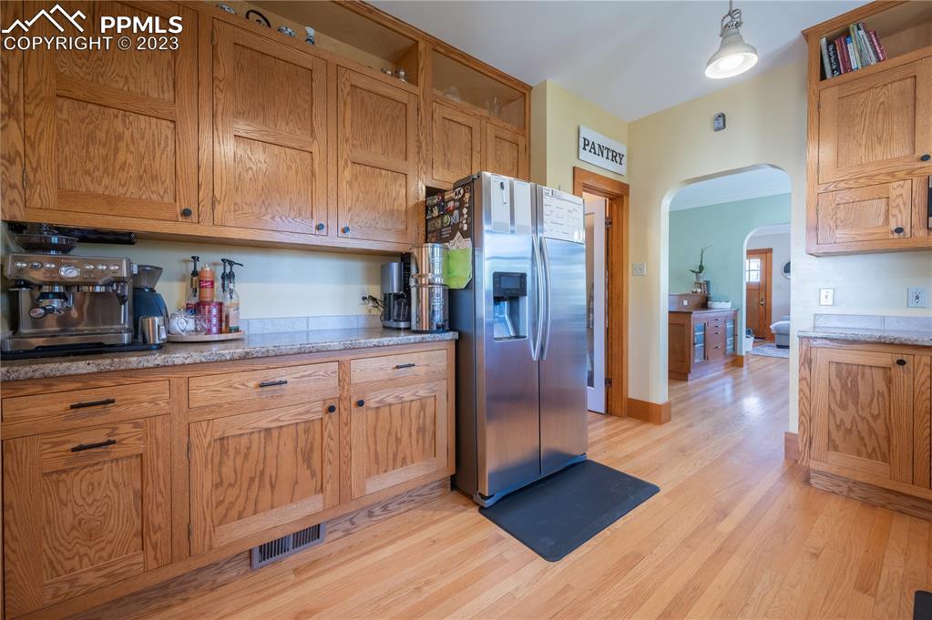 24141 Eccles Street Elbert, CO 80106 - Photo 23 of 37 a kitchen with stainless steel appliances granite countertop a refrigerator a sink dishwasher and wooden cabinets with wooden floor
