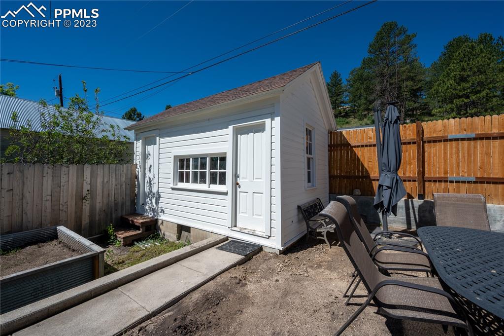 24141 Eccles Street Elbert, CO 80106 - Photo 5 of 37 a view of a deck with a table and chairs with wooden floor and plants