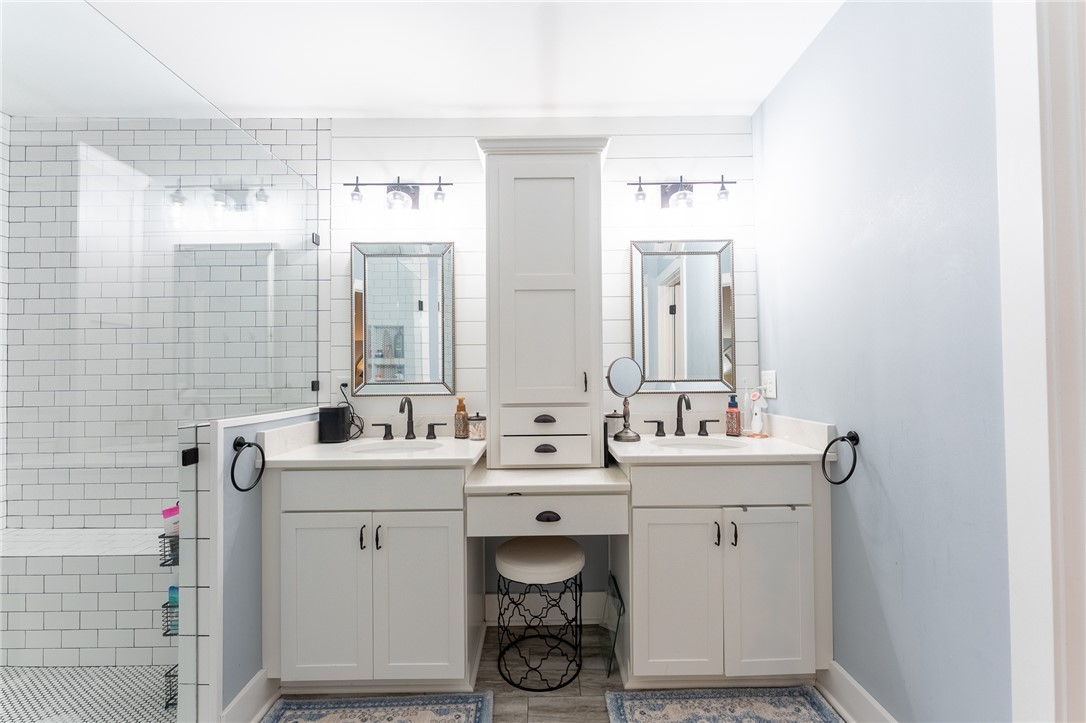 103 Riggs Drive Clemson, SC 29631 - Photo 16 of 50 Dual vanities and a spacious glass-enclosed shower create a luxurious, functional primary bathroom retreat.