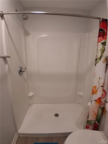 a bathroom with a bathtub and shower