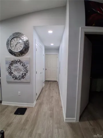 a view of a hallway with wooden floor
