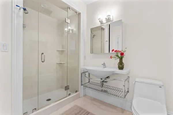 a bathroom with a sink toilet and shower