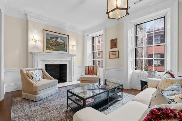a living room with furniture fireplace and window
