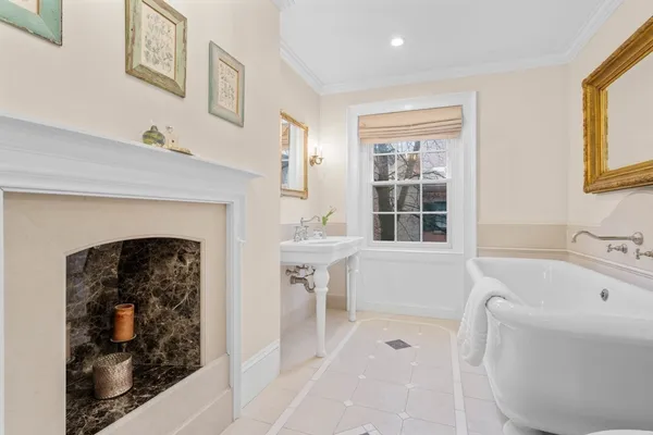 a bathroom with a bathtub sink and mirror