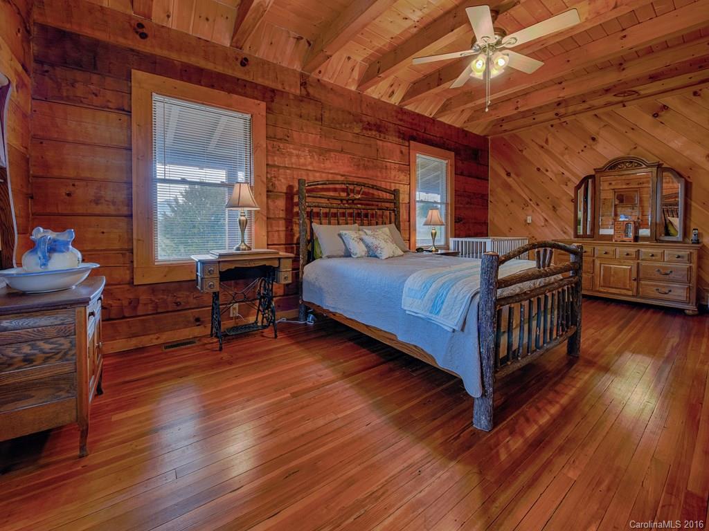 334 Ridgeview Lane Canton, NC 28716 - Photo 16 of 24 a bedroom with a bed and wooden floor