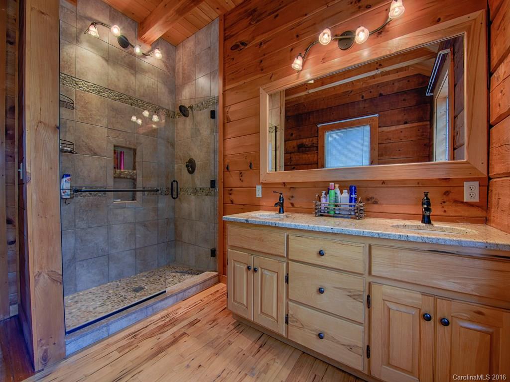334 Ridgeview Lane Canton, NC 28716 - Photo 18 of 24 a bathroom with a granite countertop sink mirror and shower