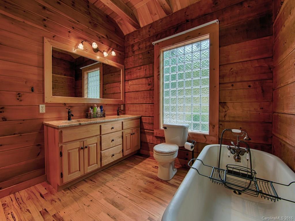 334 Ridgeview Lane Canton, NC 28716 - Photo 19 of 24 a spacious bathroom with a double vanity sink a toilet and a window