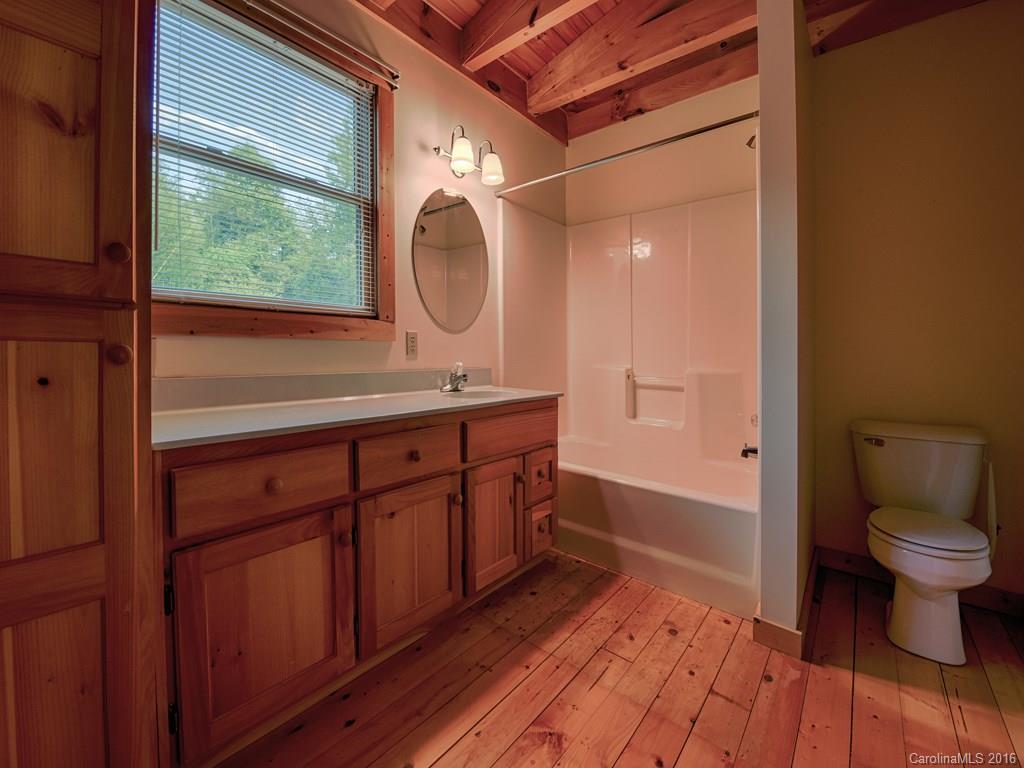 334 Ridgeview Lane Canton, NC 28716 - Photo 22 of 24 a bathroom with a sink a toilet and a mirror