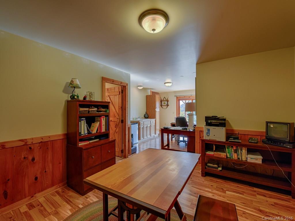 334 Ridgeview Lane Canton, NC 28716 - Photo 24 of 24 a living room with furniture a bookshelf and a wooden floor