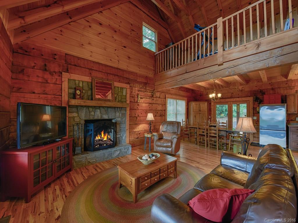334 Ridgeview Lane Canton, NC 28716 - Photo 10 of 24 a living room with furniture a flat screen tv and a fireplace