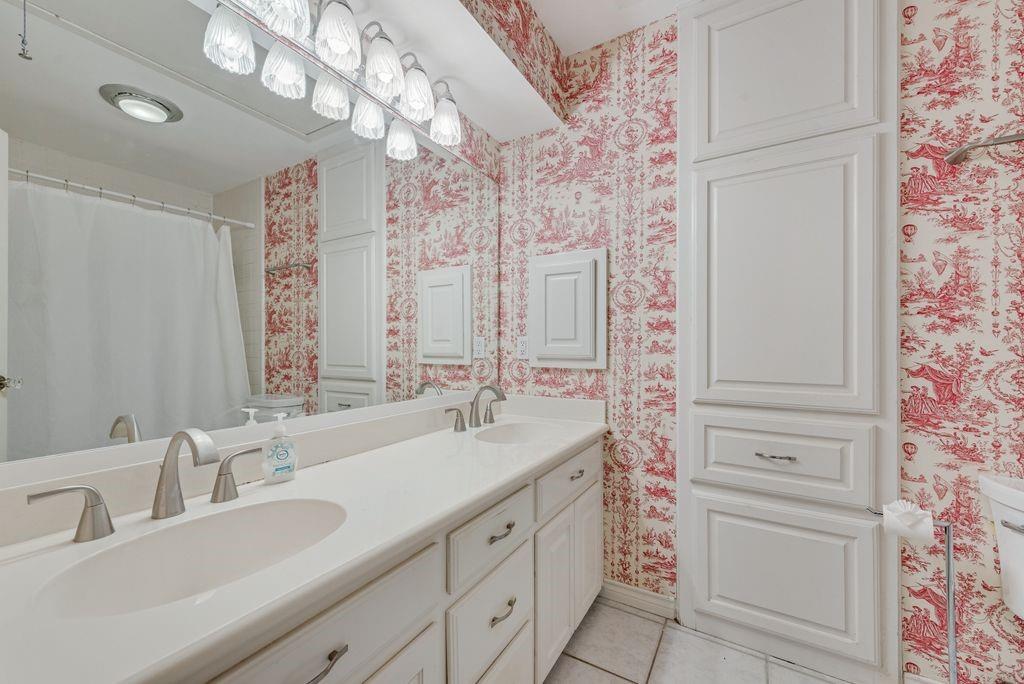 2 Eastshore Road Heath, TX 75032 - Photo 17 of 30 a bathroom with a sink a vanity and a mirror