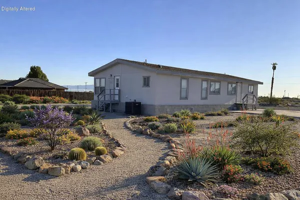 a view of a house with a yard and sitting area