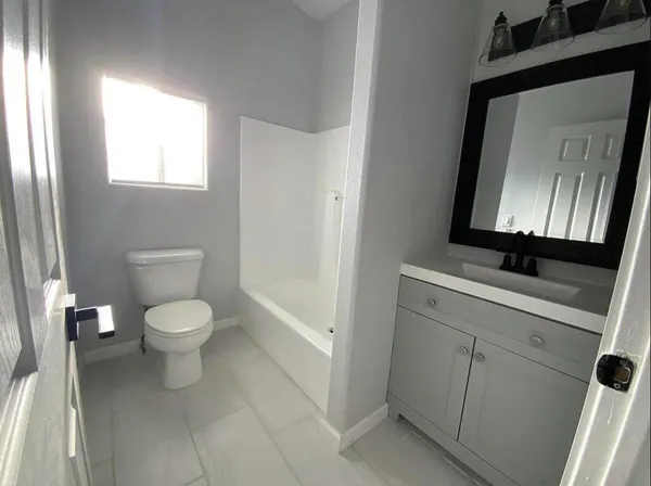 a bathroom with a toilet a sink and a mirror