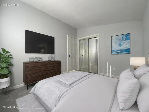 a bedroom with a bed and a flat screen tv