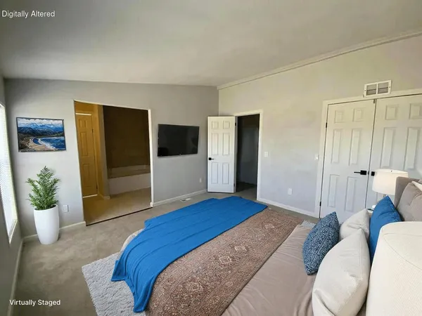 a bedroom with a bed and a couch
