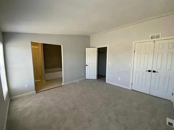 an empty room with closet area