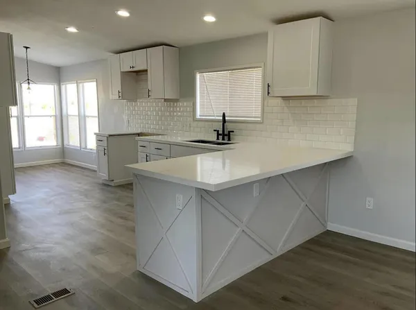 a kitchen with a sink cabinets and window