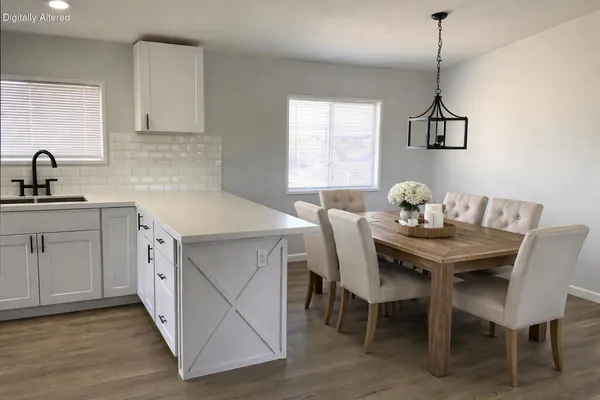 a kitchen that has a table and chairs in it