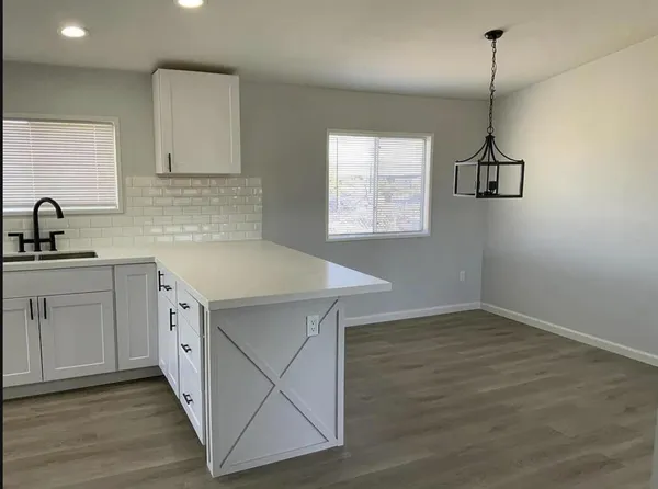 a kitchen with sink cabinets and wooden floor