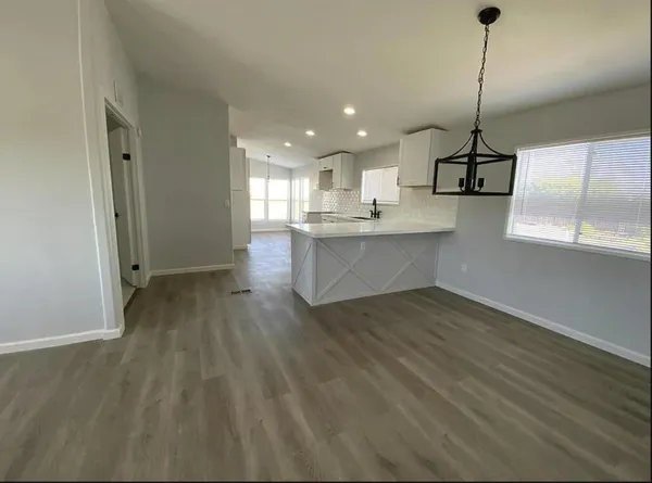 a view of a kitchen with a sink cabinets and wooden floor