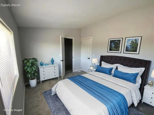 a bedroom with a bed and a couch
