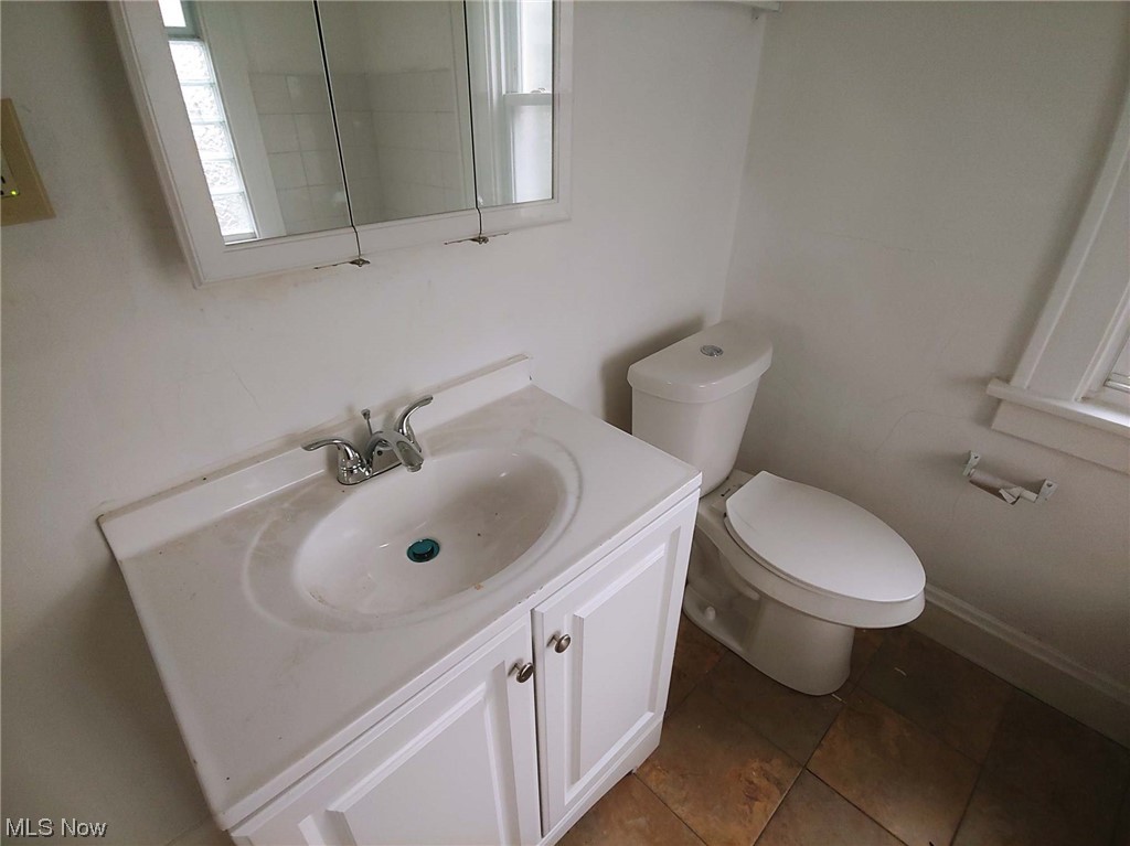 1464 Sherbrook Road Cleveland, OH 44121 - Photo 10 of 15 Bathroom with tile floors, toilet, and oversized vanity