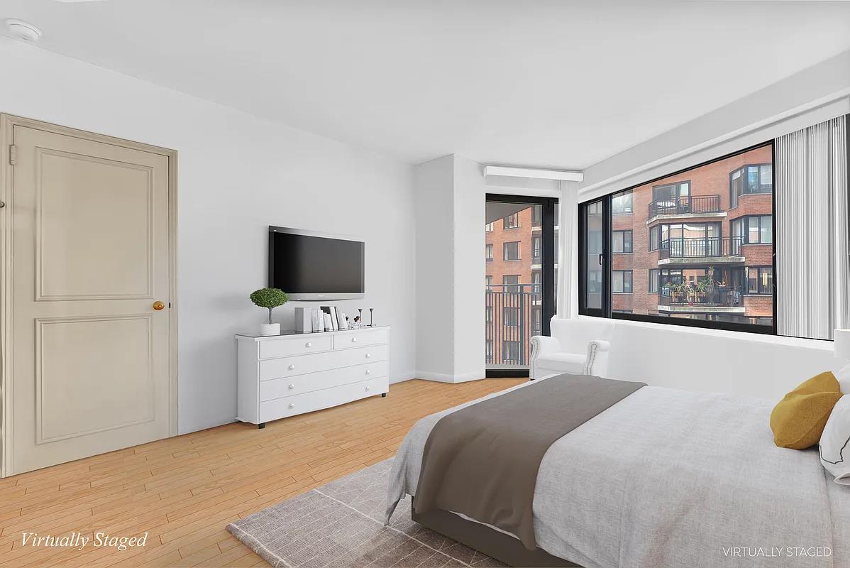 60 Sutton Place South, Unit 11FN Manhattan, NY 10022 - Photo 3 of 10 a bedroom with a bed and a flat screen tv