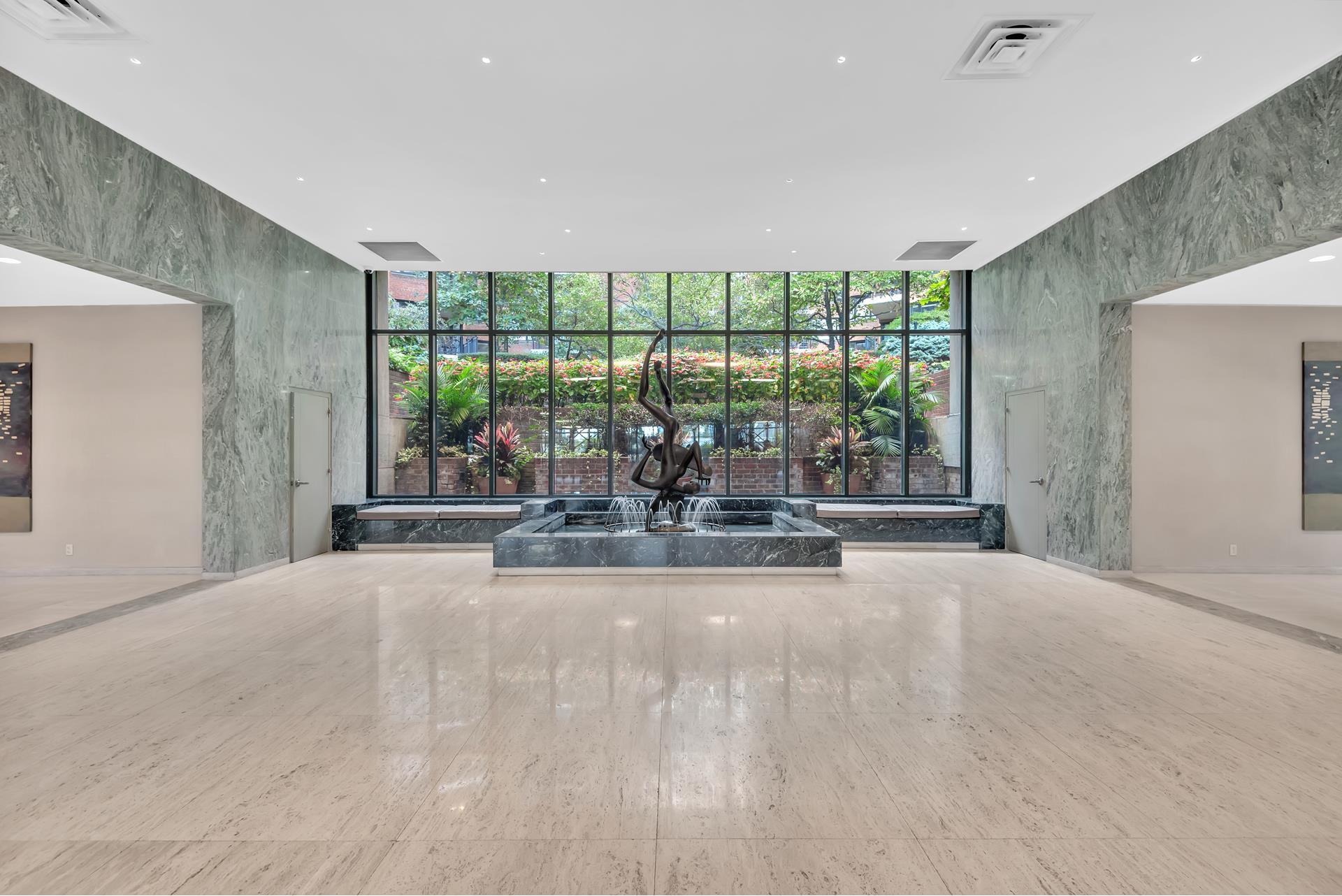 60 Sutton Place South, Unit 11FN Manhattan, NY 10022 - Photo 5 of 10 a view of a room with gym equipment and large windows