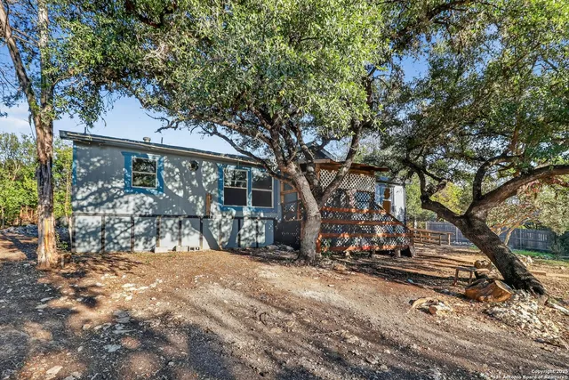 a view of a house with a tree in the background