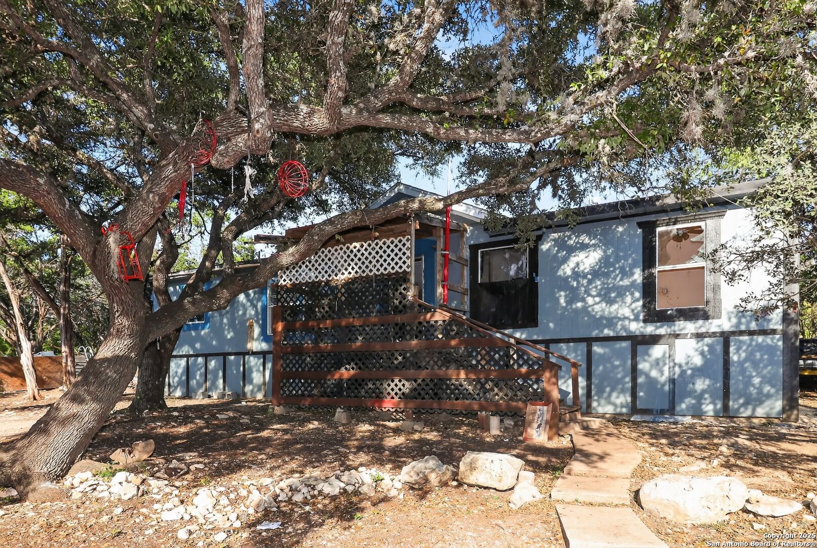 833 High Drive Spring Branch, TX 78070 - Photo 2 of 30 a tree in front of a white house