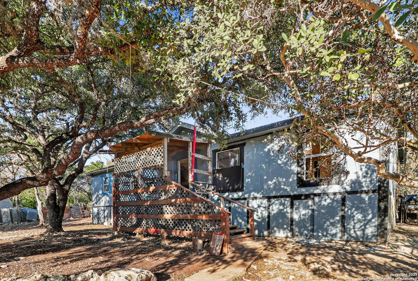 833 High Drive Spring Branch, TX 78070 - Photo 4 of 30 a tree in front of a white house