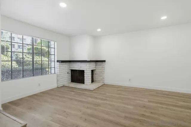 wooden floor in an empty room with a fireplace