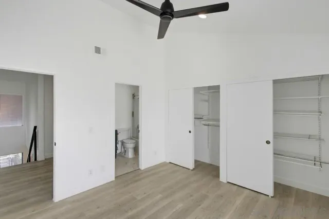 a view of empty room with wooden floor and window