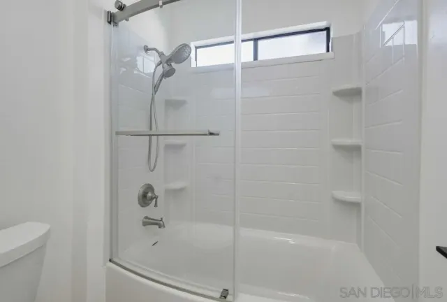 a bathroom with a shower and a toilet